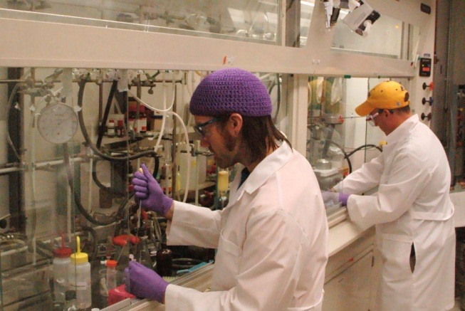 Lab workers in laboratory workplace settings wearing proper personal protective equipment
