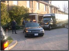 Police car escorting a shuttle